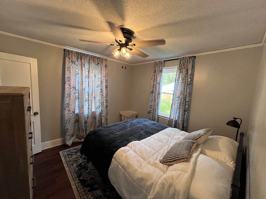 Bedroom 2 with queen bed, closet, and dresser. 