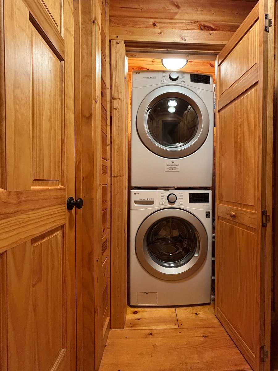 Laundry closet with washer/dryer, starter detergent, flashlight and umbrella.