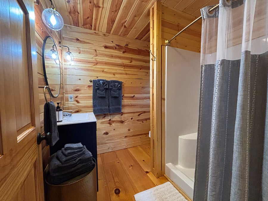 Main-level bathroom with walk-in shower, hair dryer and starter essentials.