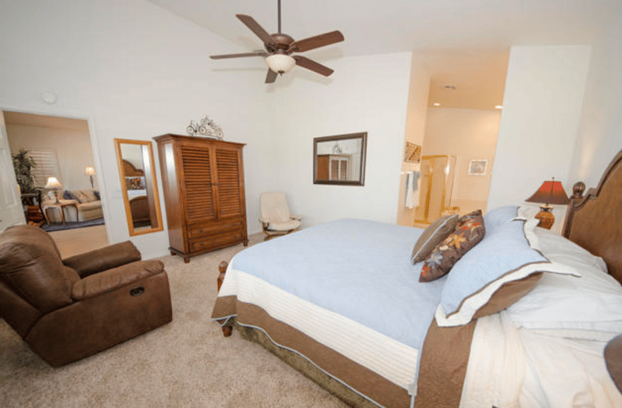 Primary bedroom with view of golf course and mountains
