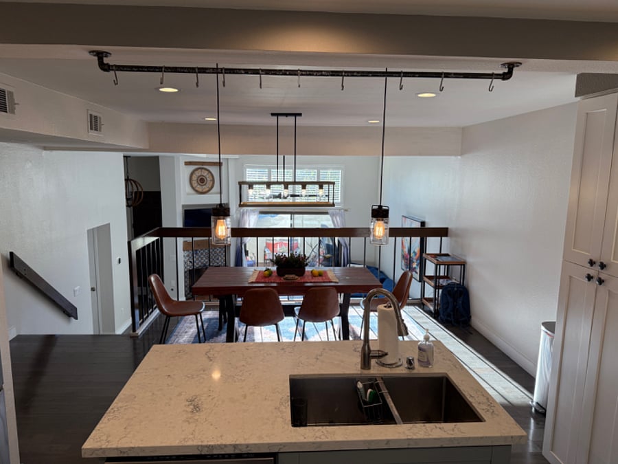 Kitchen view through dining, living and patio