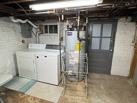 The washer/dryer, drying rack and priuvate rear entrance/exit are next to the private bathroom.
