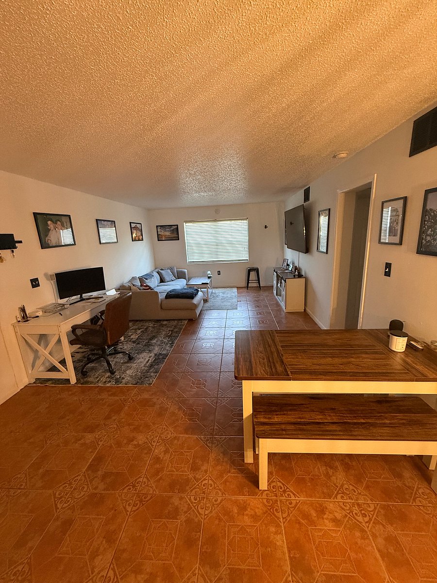 Open concept with farm-style dining table, work from home station (monitor included), comfy couch and large smart TV!