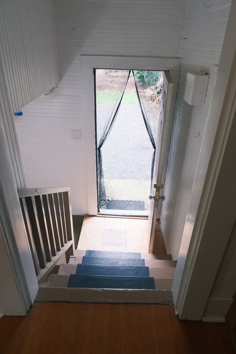 Door to backyard, stairs to basement