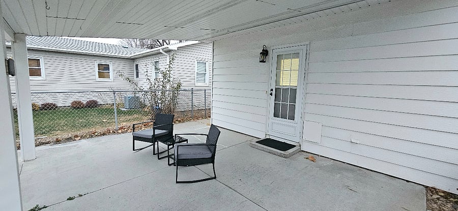 Covered outdoor patio with seating.