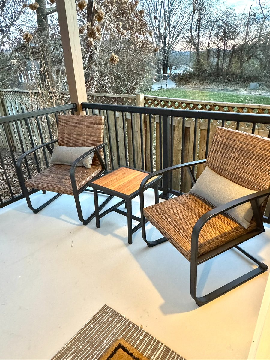 Front entrance in the evening with two rockers and small table.