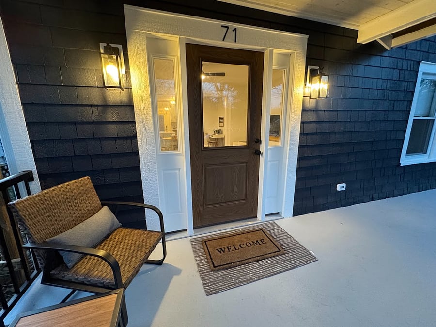 Front entrance in the evening with two rockers and small table.