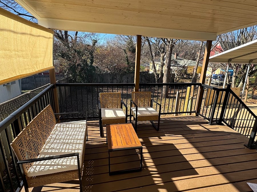 Back deck with fenced in yard, sun/privacy shade, grill and patio furniture.