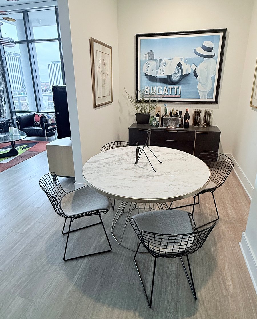 Separate Dining Area with Modern Marble Round Table with Authentic Bertoia Wire Chairs,  Bar/Side Cabinet wrapped in Stingray Skin & Amazing Art Collection