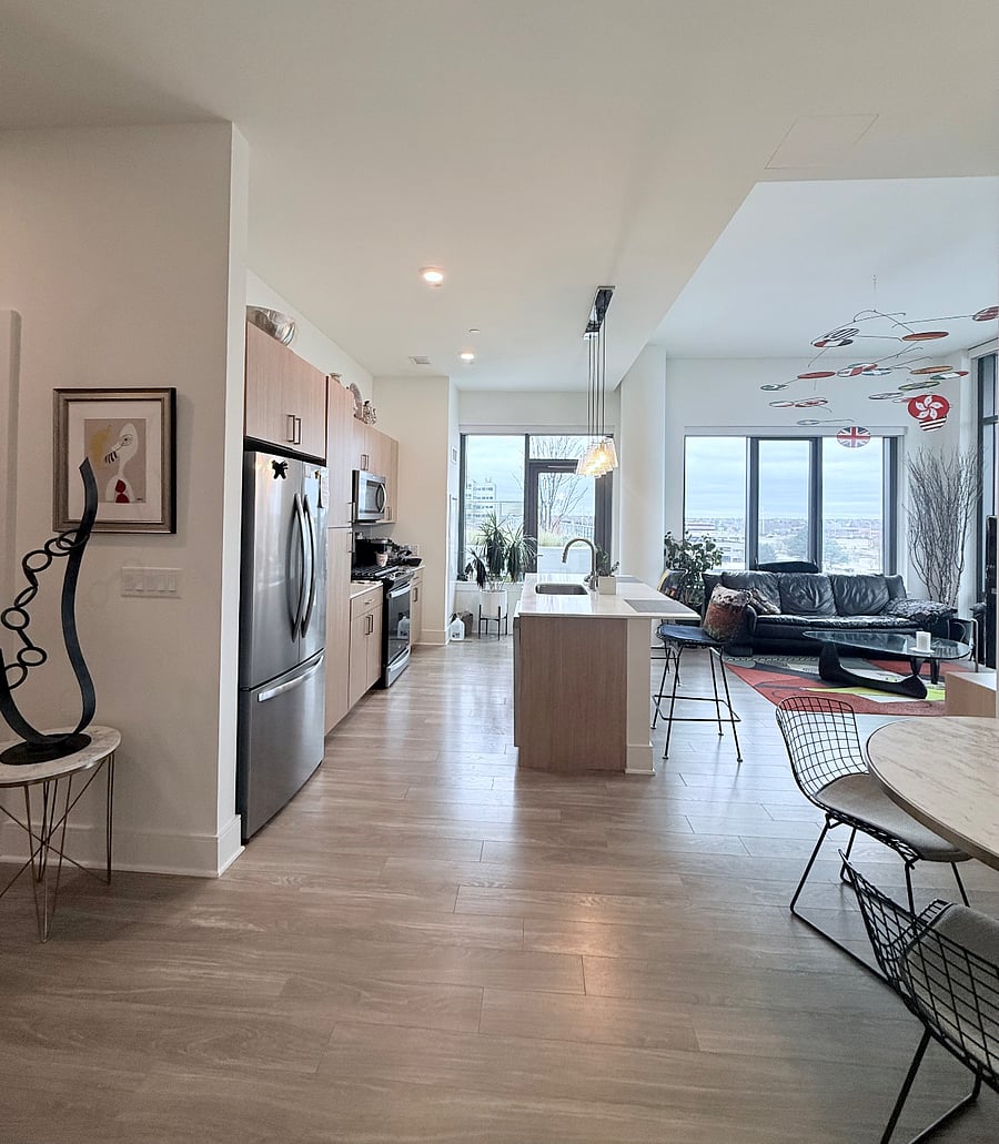 View of the Designer Kitchen, with Dual Counter Eating Area & Mid-Century Modern Living Room 