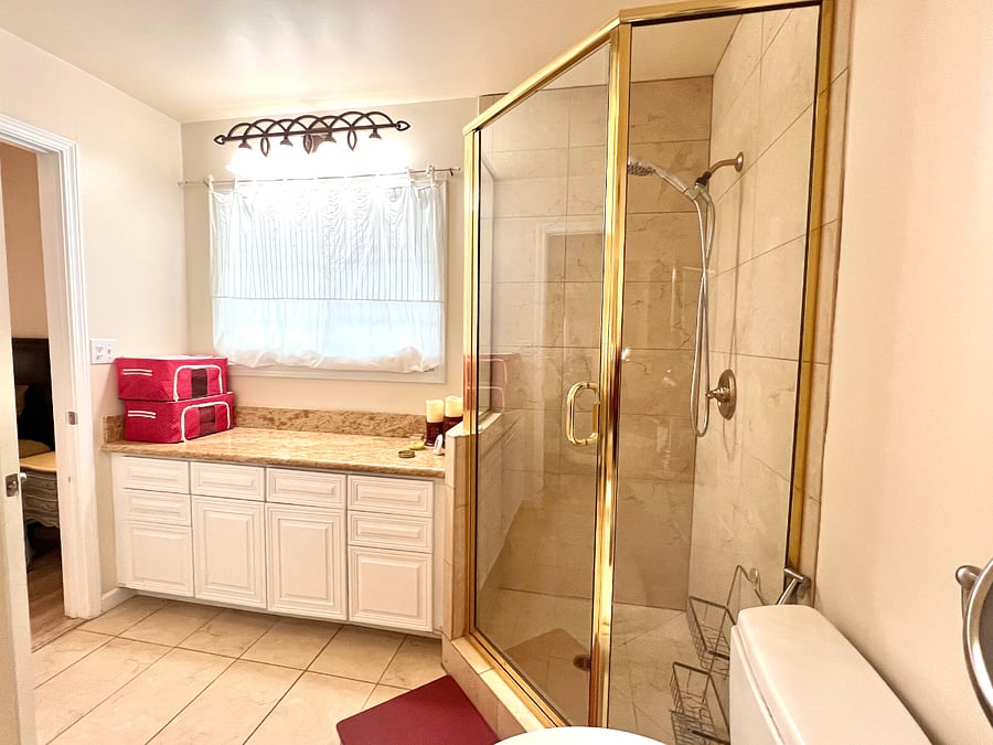 spacious bathroom with granite slab, cabinets and drawers. Towel Storage on the counter