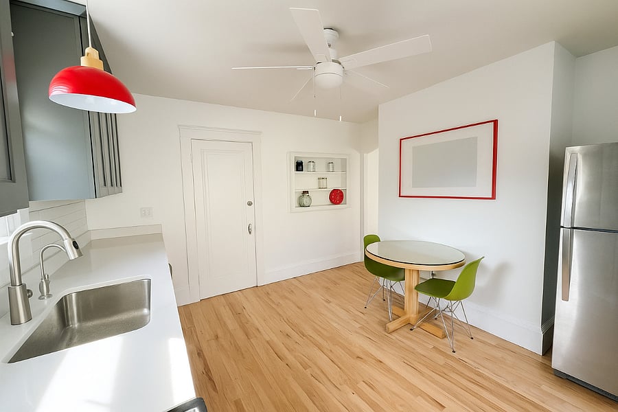 Under-cabinet lighting and sleek finishes add warmth and function to this newly renovated kitchen.