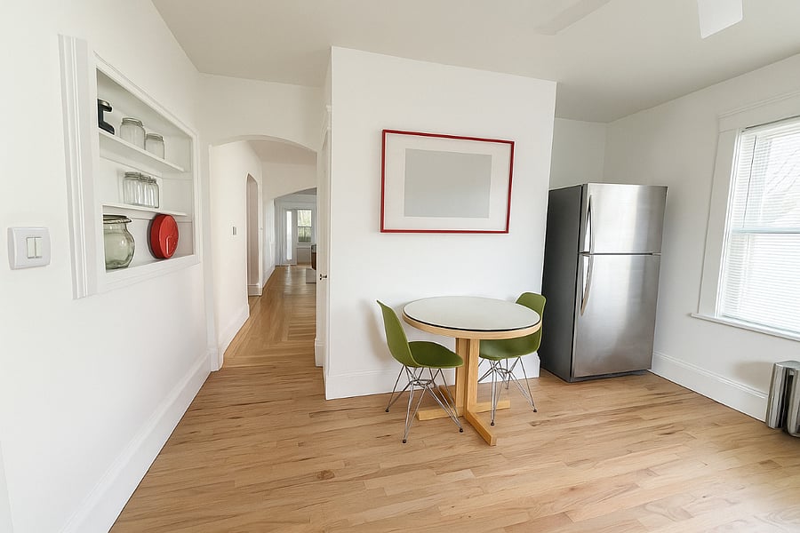 Refinished butcher-block dining table and mid-century chairs create a light, inviting space.