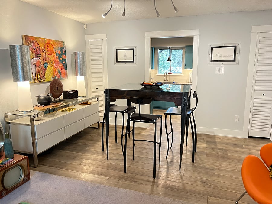 The dining area is anchored by a custom table and original artwork by local artists.