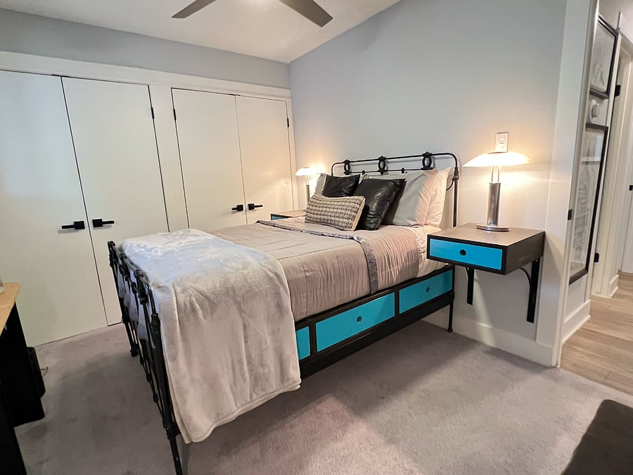 The guest bedroom has a full size bed, 2 closets and custom furniture.