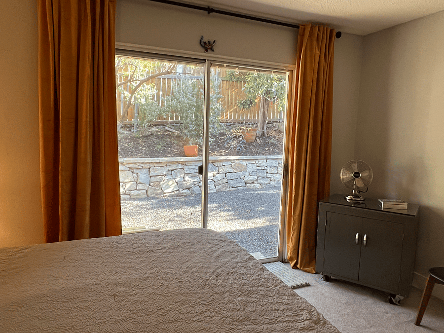 The spacious Master Bedroom opens to the terraced back yard