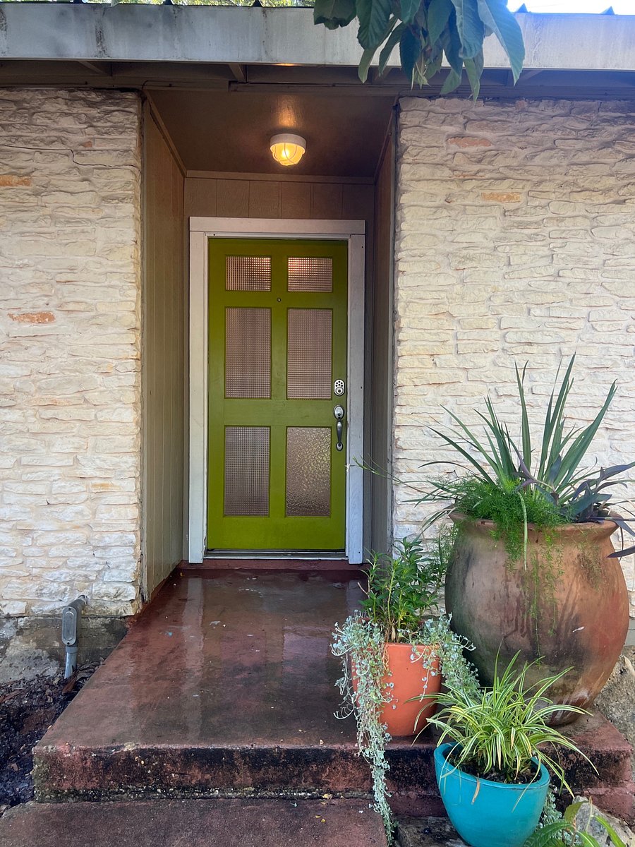 This is the front door. There are 4 steps up to the house which is elevated about 3 feet above the Carport and about 8 feet above Elmhurst Drive.