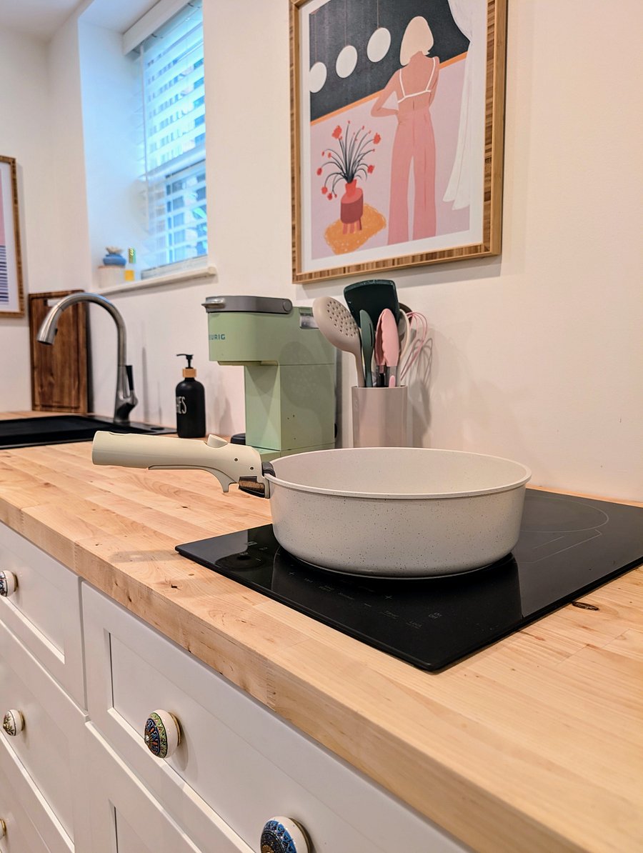 The kitchenette is newly installed and features a full sink, 2 burner cooktop and spacious refrigerator. It is stocked with utensils, plates and cups, while offering plenty of additional storage in drawers.