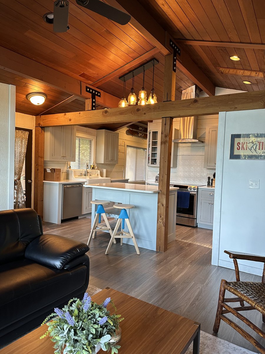 Enjoy the curated ambiance of a true Mid Century home. 1940's Koler Farmhouse Sink, Cedar plank Ceilings, recycled shiplap custom inset cabinetry & Island seating w/ Tom & Jerry Stools. Timber Frame Beam construction and hand blown chandelier lighting.