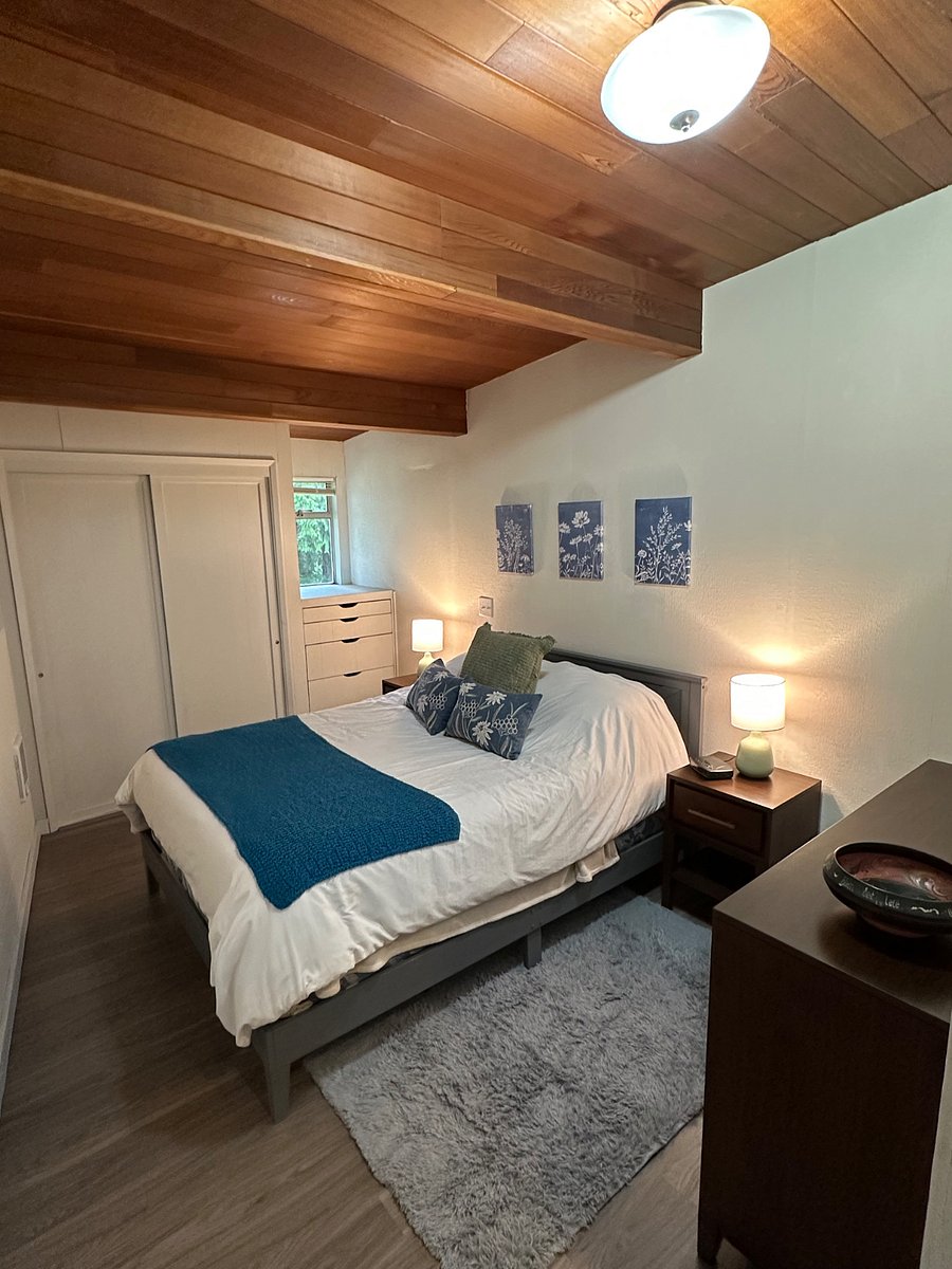 Queen size platform bed, Crate & Barrel walnut dresser and night stands with a rustic touch of an Old Hickory chair create a space that is warm and inviting