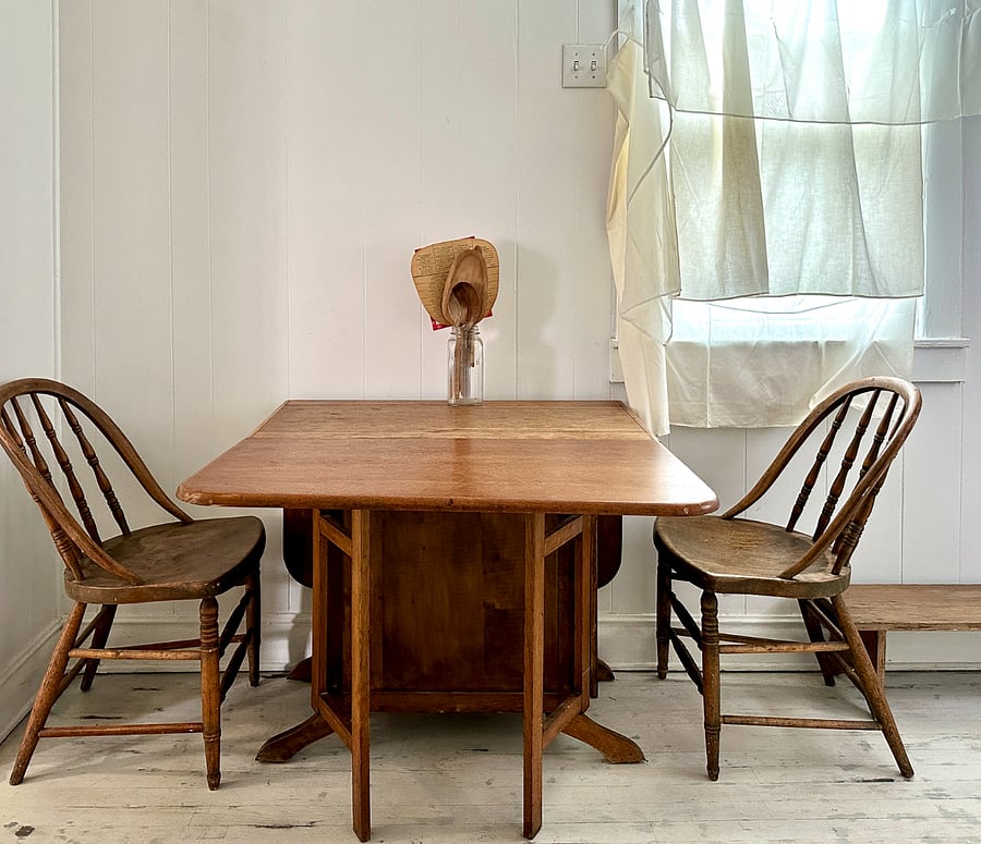 Gateleg table unfolded. Various sets of placemats and cloth napkins stored in the closet.