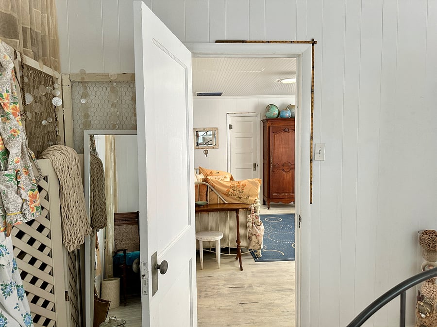 Mirror and additional screens are stored behind the bedroom door.