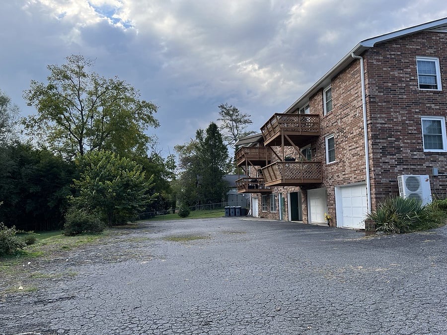 Rear parking area. Each unit has a one car garage. This unit offers private access from inside as well as outside.