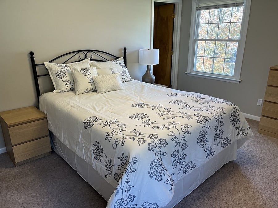 Cozy tempurpedic queen size bed in main bedroom. Two windows for generous natural light. Dresser and nightstands available for storage.