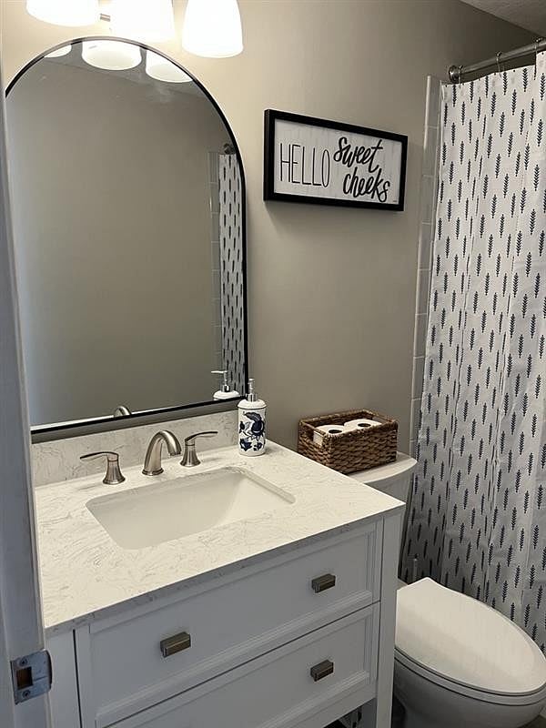 Main bath with remodeled tile shower, new vanity, toilet and floors. Non-slip bathmat included.