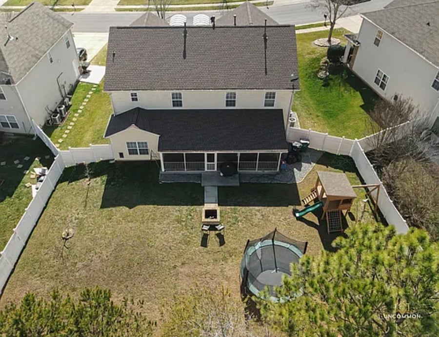 Backyard- Fire pit, grill, kid's playhouse.