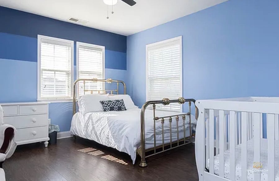 Bedroom with Queen bed and baby crib.