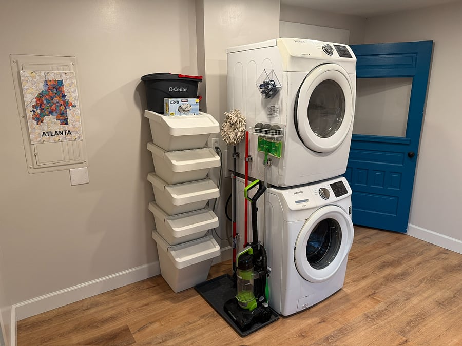 Washer/Dryer with cleaning supplies.