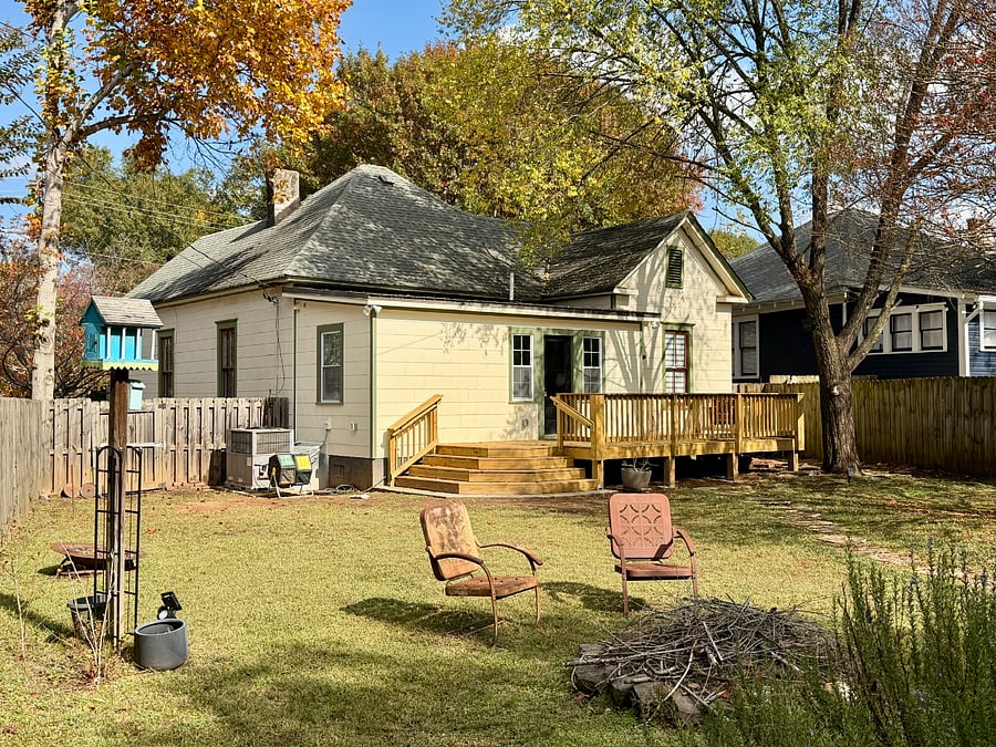 Fire pit area with accessible water hose for precautionary measures.