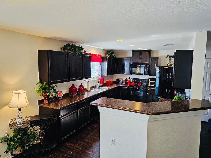 Full kitchen with electric range, oven, microwave, fridge.