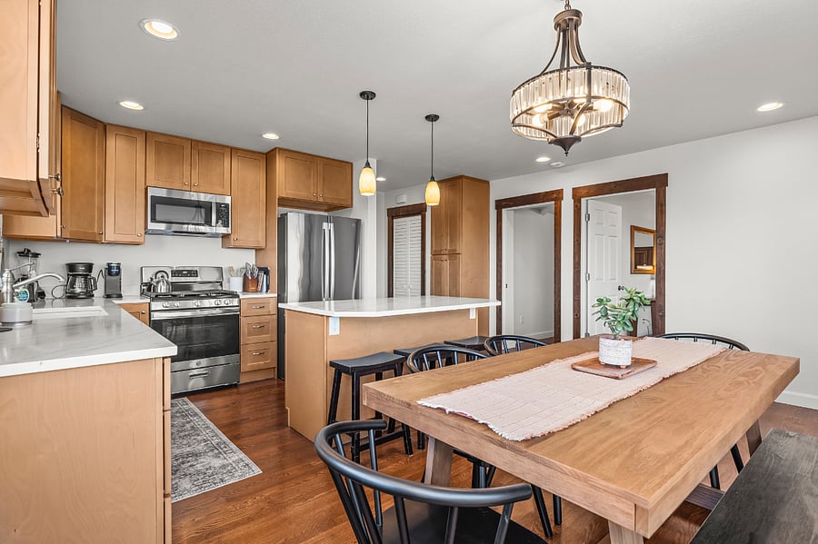 Kitchen and dining area connects to the living room, family room, and hall to laundry room and another bedroom