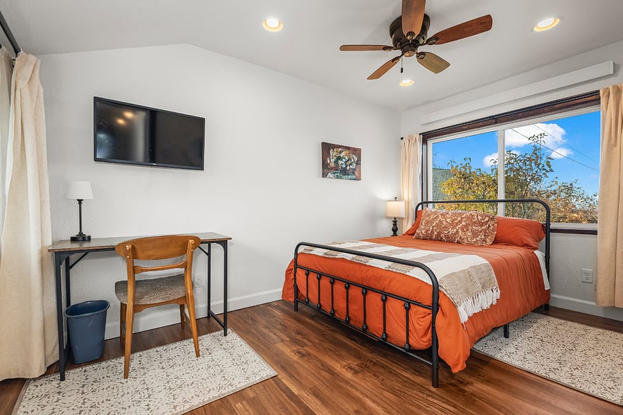 Light filtering curtains and dedicated work space. Roku TV has articulating wall mount for easy viewing from bed