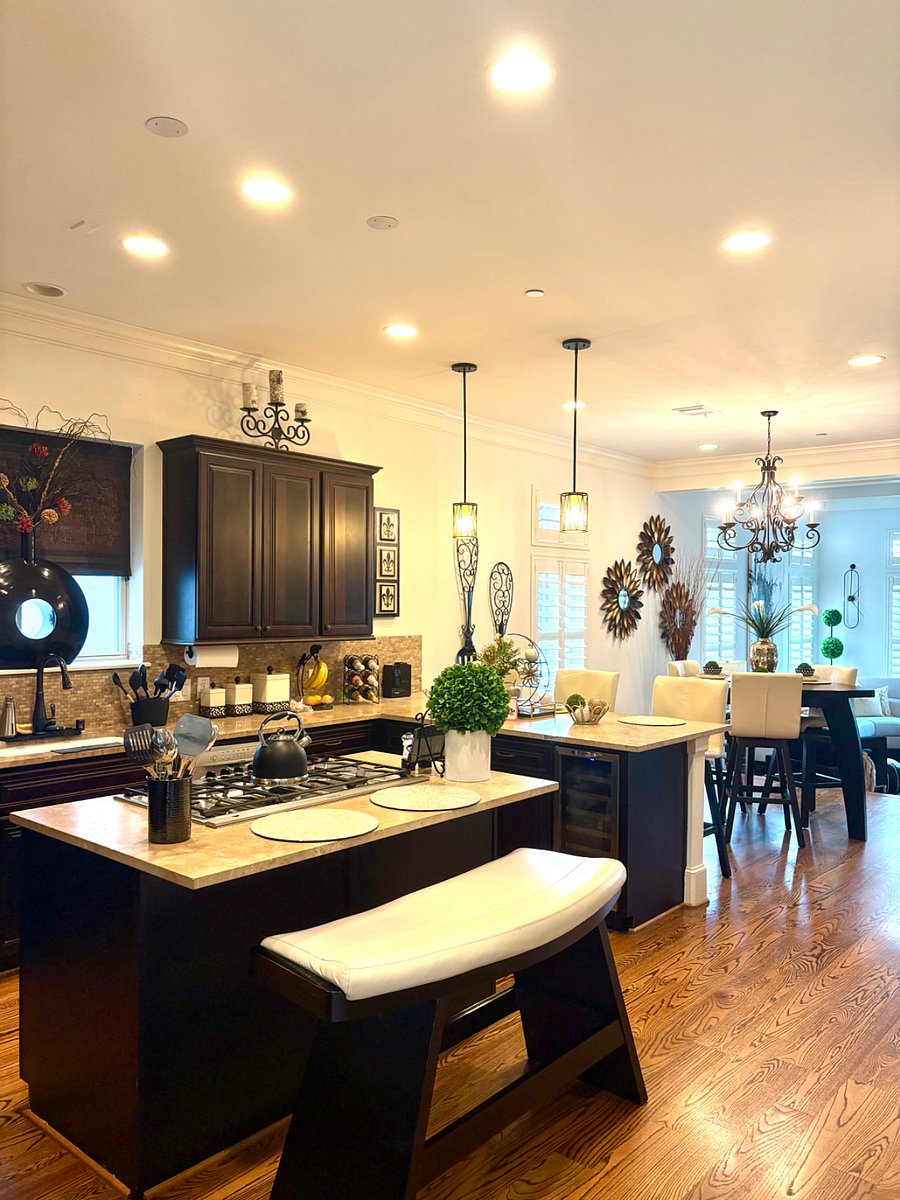 Full kitchen with island stovetop and sitting areas on second floor