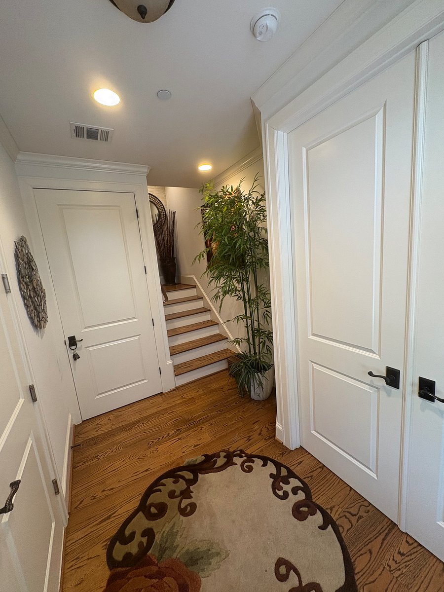 Home foyer with private bedroom with double doors entrance on right