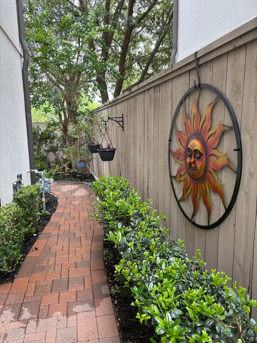 Brick pathway to backyard garden.