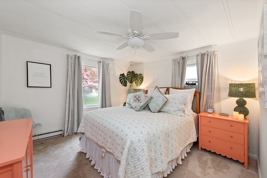 Master bedroom with lots of natural light, ceiling fan - airco window unit in house for extra comfort