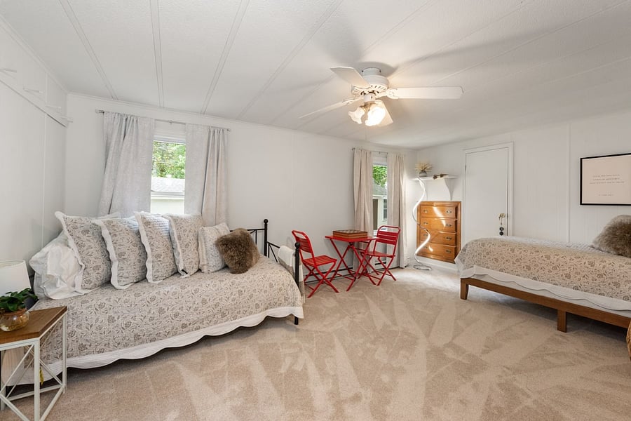 Spacious second bedroom with two single beds and luxury linens
