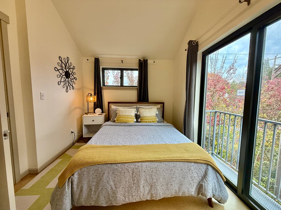 Comfortable queen guest room with black out curtains, dresser, desk, closet!