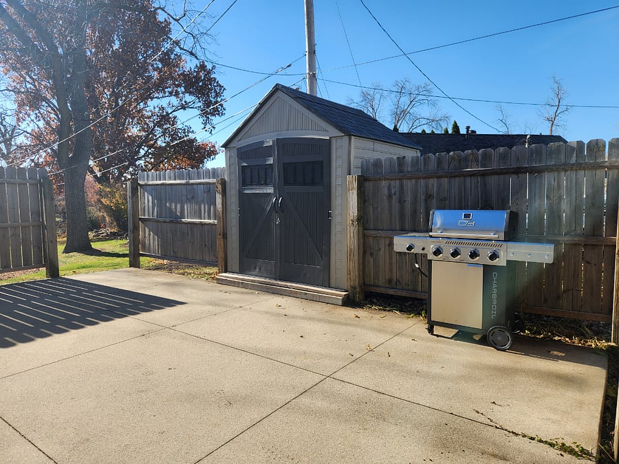 Grill, Storage Shed, and Privacy Fence in Back Yard