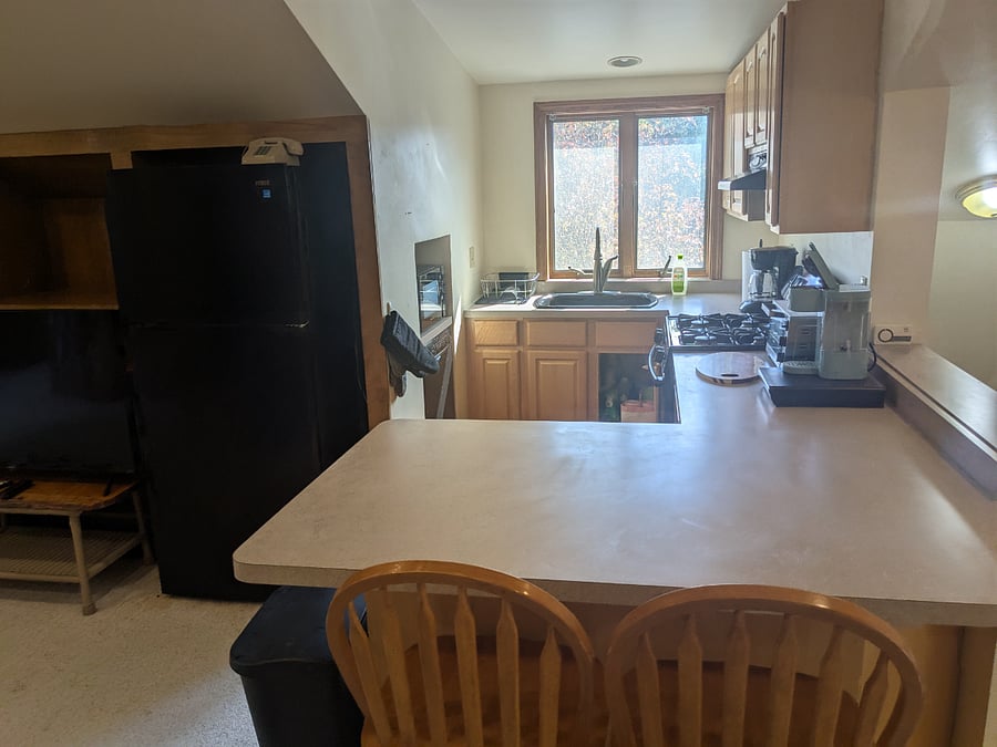 Kitchen - full size fridge (pictured to the left) + beverage fridge under counter Location on second floor Additional seating for two with counter stools. Dishwasher and microwave on the wall to the left of the sink.
