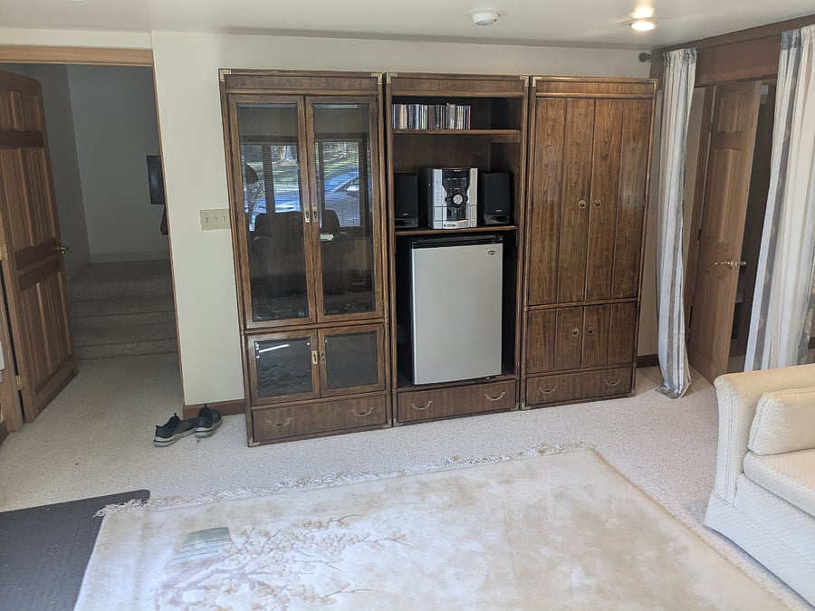 Downstairs living Room second view - Wall unit with "kitchenette" arrangement. Small fridge, sink behind doors to the right, microwave, toastreoven + coffee maker