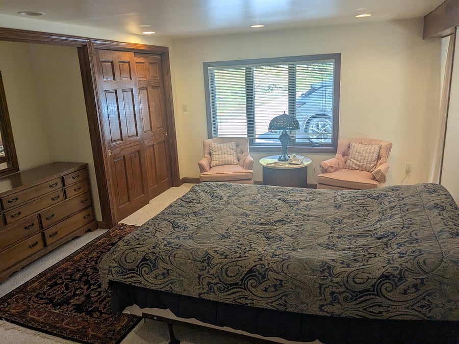 Downstairs Queen Bed (very comfortable) Two 6 ft closets/ 6 ft dresser and double chair sitting area