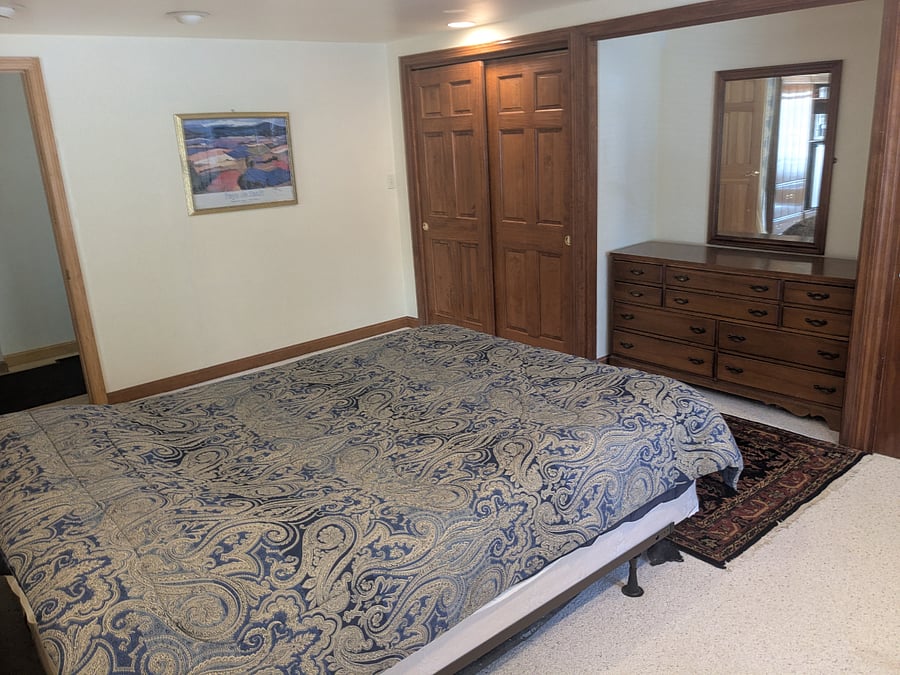 Downstairs large bedroom - second view Two 6ft wide closets on either end of pictured dresser