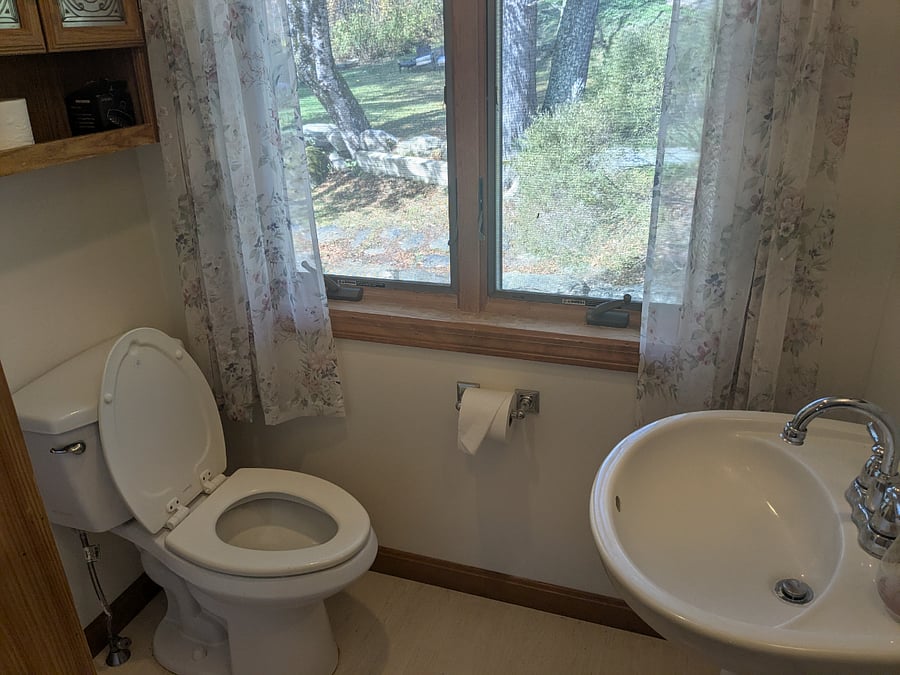 Large Upstairs Bathroom. Full bathtub with shower option. Views from bathroom window is to back of the property Tucked away closet for towel storage.