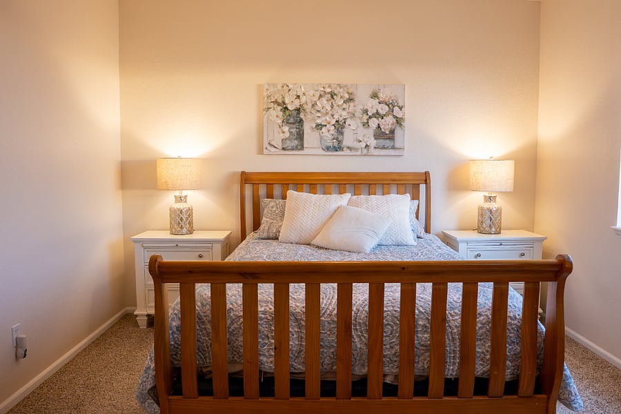 Master Bedroom has a queen bed with an adjustable base. The end tables have a pull out shelf.