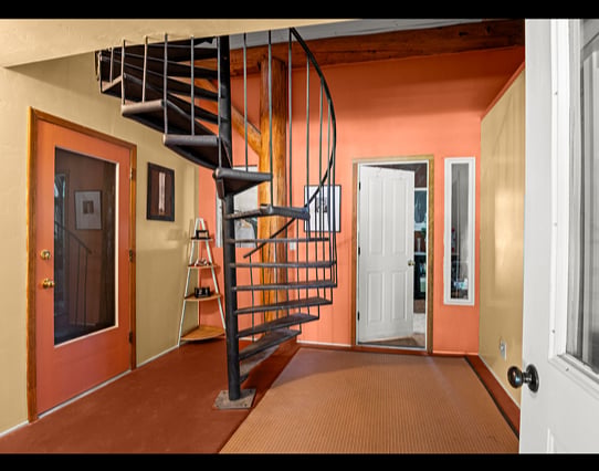 "Bunkhouse" lower level entry with interior spiral stair case - bedroom straight ahead and bathroom to right